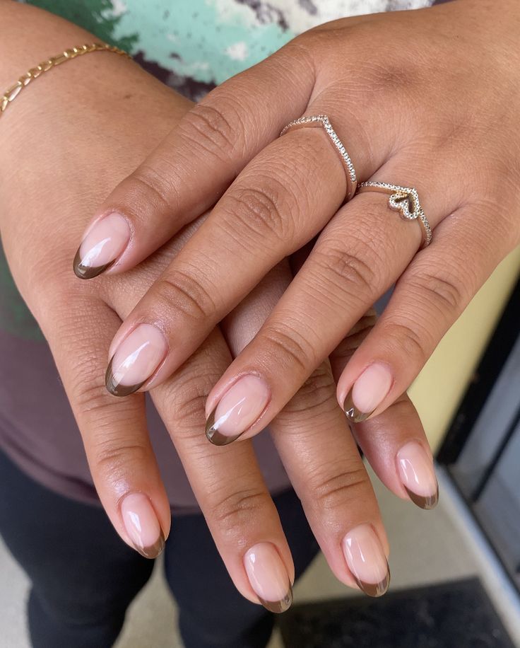 Sophisticated Twist on Classic French Tip Manicure with Soft Nude Base and Rich Brown Tips.