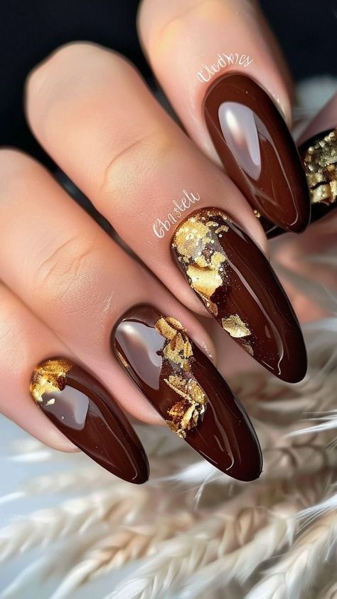 Luxurious Almond-Shaped Nail Design in Deep Chocolate Brown with Gold Flakes.