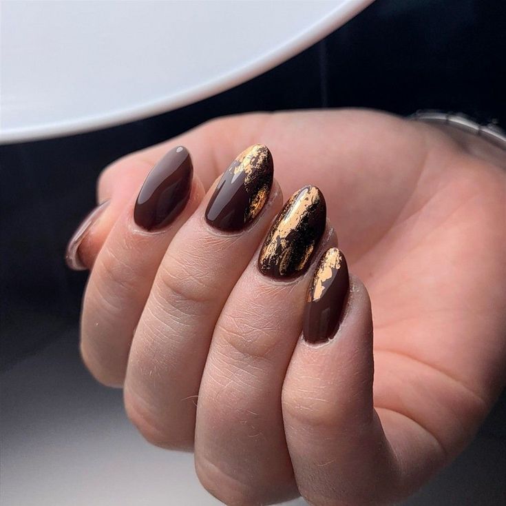 Chic Almond-Shaped Nail Design: Rich Brown Base with Striking Gold Foil Accents