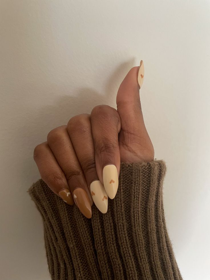 Chic Almond-Shaped Nail Design with Heart Accents in Soft Beige and Light Brown Matte Finish