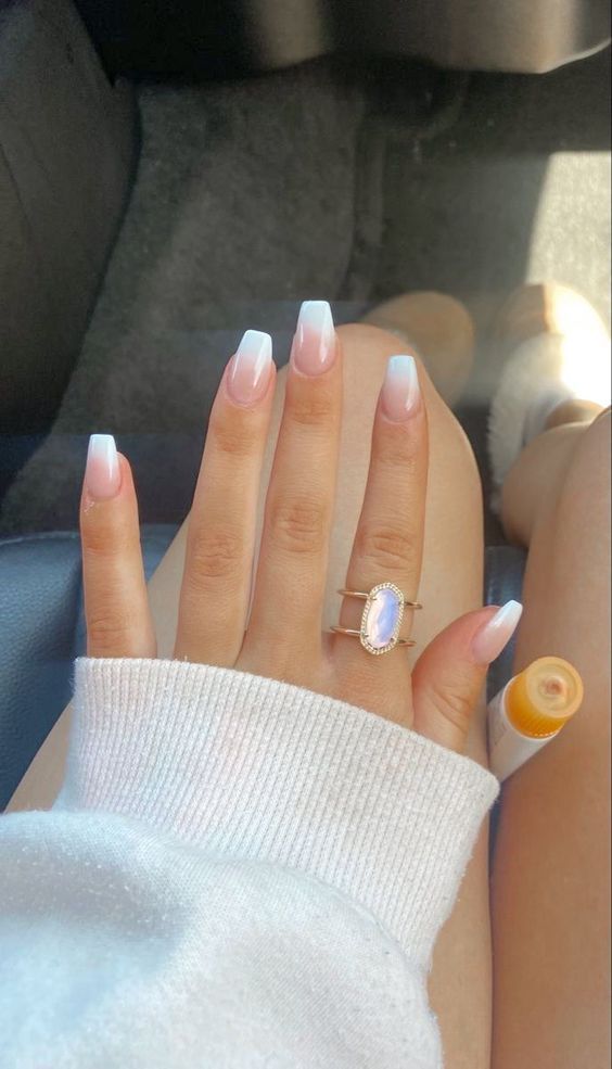 Chic Soft Pink and White Gradient Nail Design with Delicate Ring Accents.