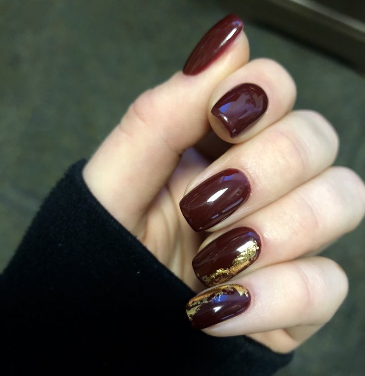 Sophisticated Burgundy Manicure with Glossy Finish and Gold Foil Accents.