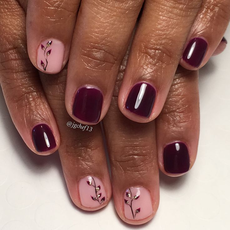 Sophisticated Nail Design: Deep Burgundy and Soft Pink with Floral Patterns and Embellishments