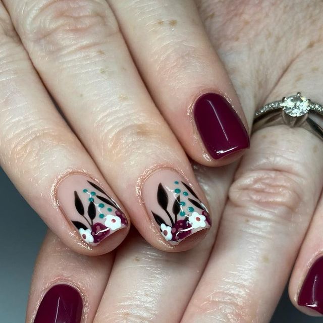 Elegant Floral Nail Design Featuring Deep Burgundy, Soft Nude, and Intricate Details.