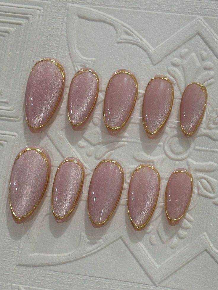 Sophisticated Soft Pink Glossy Nail Design with Delicate Golden Accents for Any Occasion