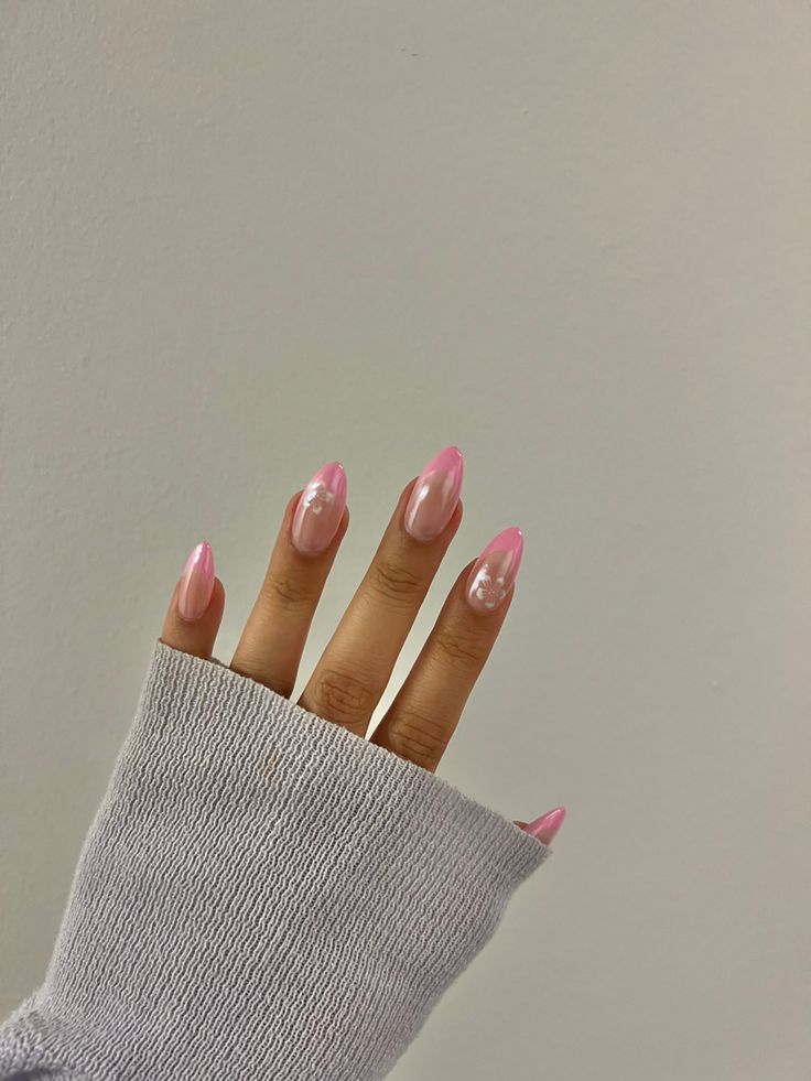 Elegant Almond-Shaped Pink Gradient Nails with Delicate Design and Subtle Embellishments.