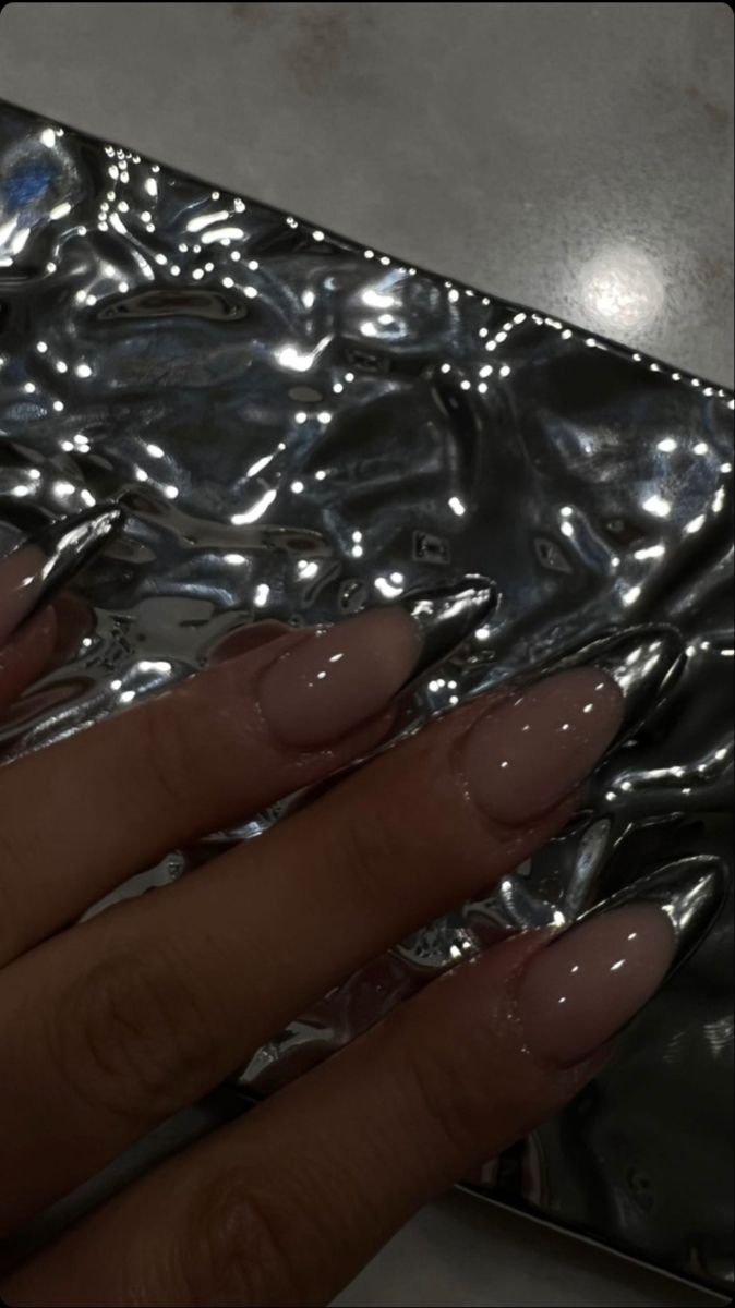 Chic Nail Design: Soft Nude Polish with Metallic Silver Tips for a Sophisticated Look.