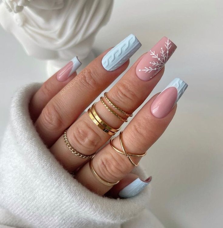 Chic Nail Design: Light Blue and Soft Pink with Geometric Patterns and Floral Accents.