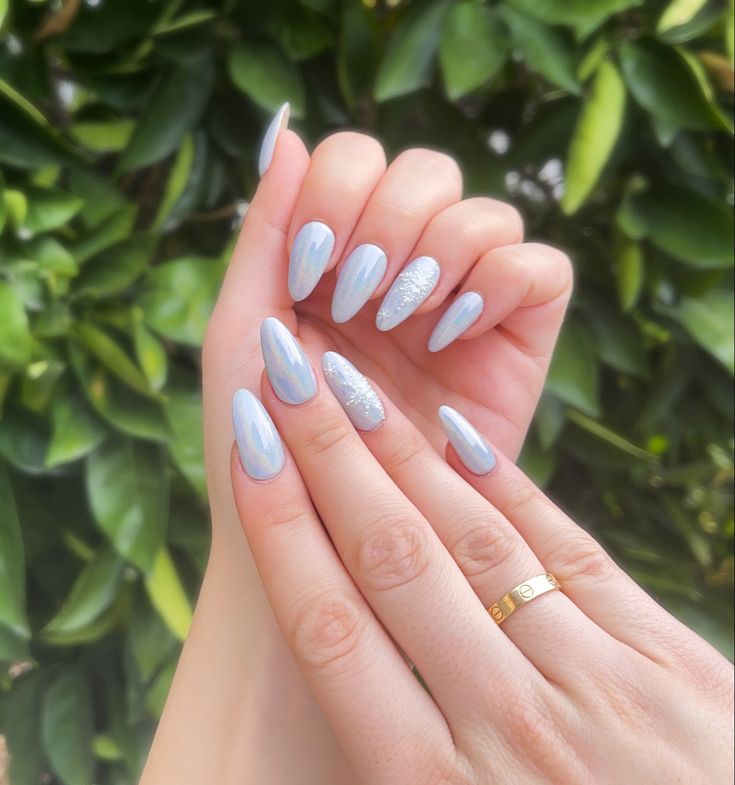 Sophisticated Light Blue Nail Design with Shimmering Silver Accents and Elongated Shape.