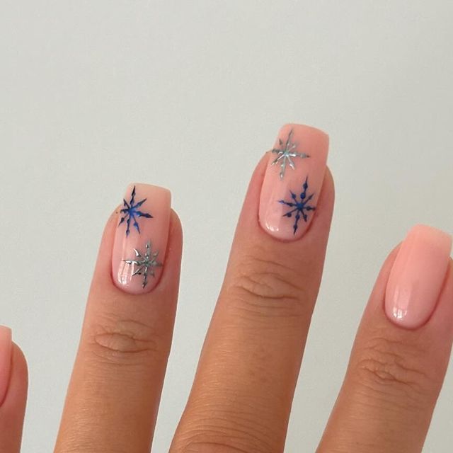 Elegant Pastel Winter Nails with Intricate Snowflake Designs