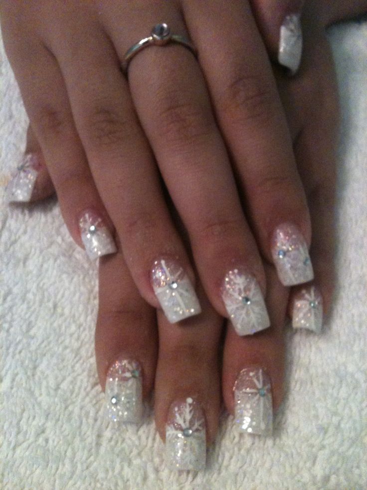 Sophisticated Nail Design with Soft White Base and Sparkling Accents.