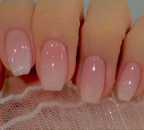 Elegant Soft Ombre Nails with Sheer Blush and Shimmering Accents