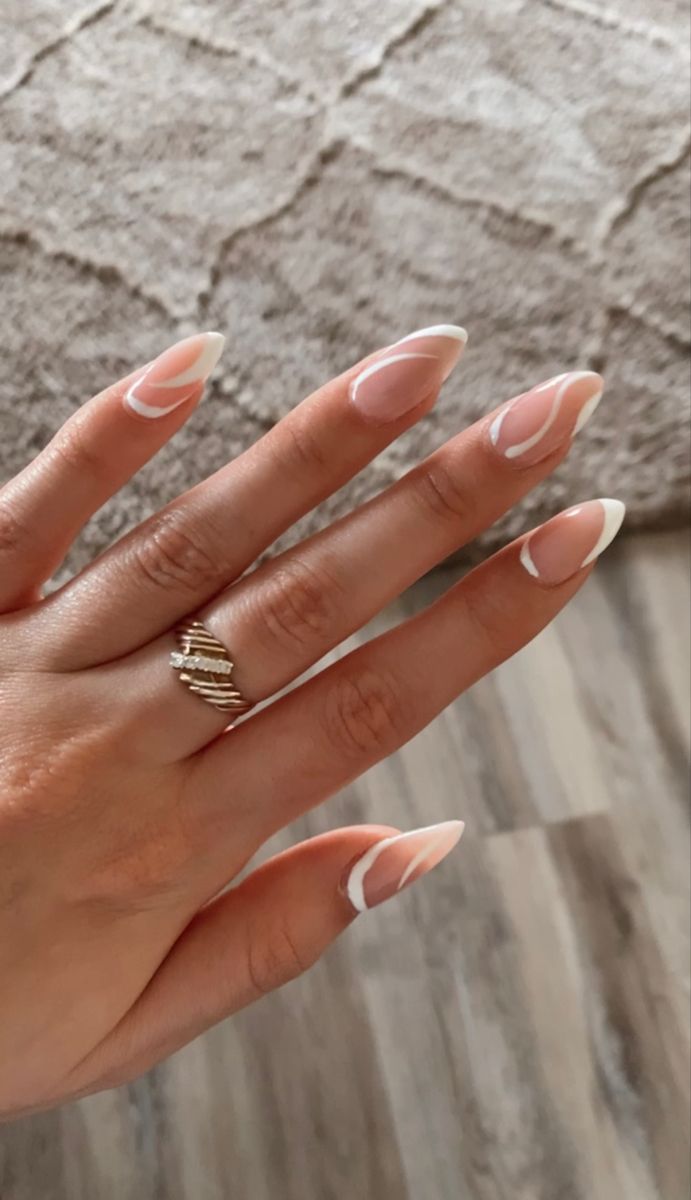 Chic Nail Design: Soft Nude Base with Elegant White Tips and Modern Curved Accents.