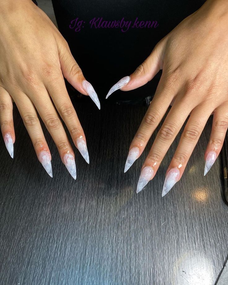 Elegant Ombre Long Stiletto Nails: Soft Pink to Translucent White with a Shiny Finish.