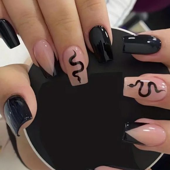 striking Black and Nude Nail Design with Snake Motifs and Geometric Accents.