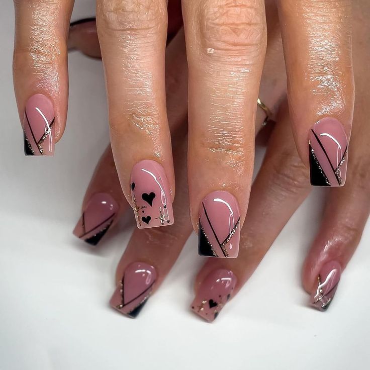 Modern Geometric Nail Design: Bold Black and Soft Pink with Playful Elements.