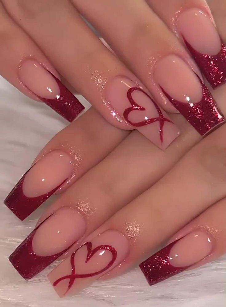 Chic Romantic Nail Design with Deep Red Gradient, Glitter Tips, and Heart Accents