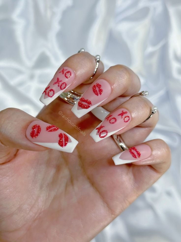 Playful Red Lip Print Nails with Elegant French Tips and Glittery Accents for a Glamorous Look.