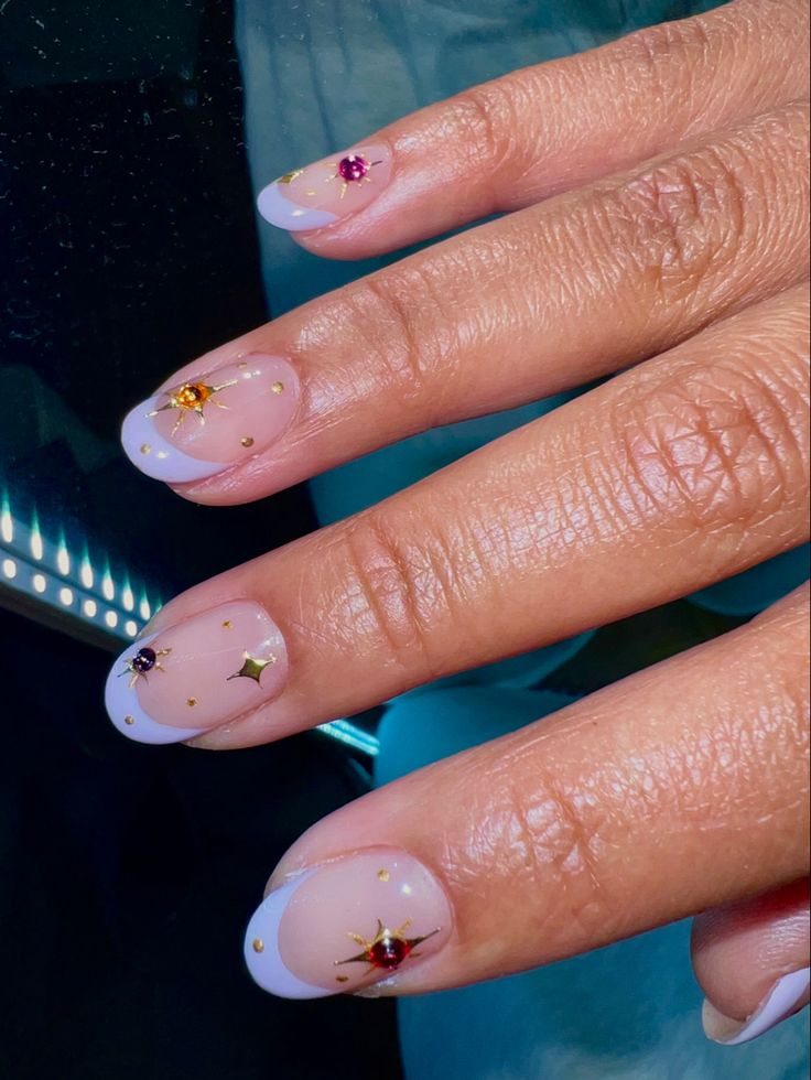 Sophisticated Nude Gradient Nail Design with Colorful Gems and Gold Accents