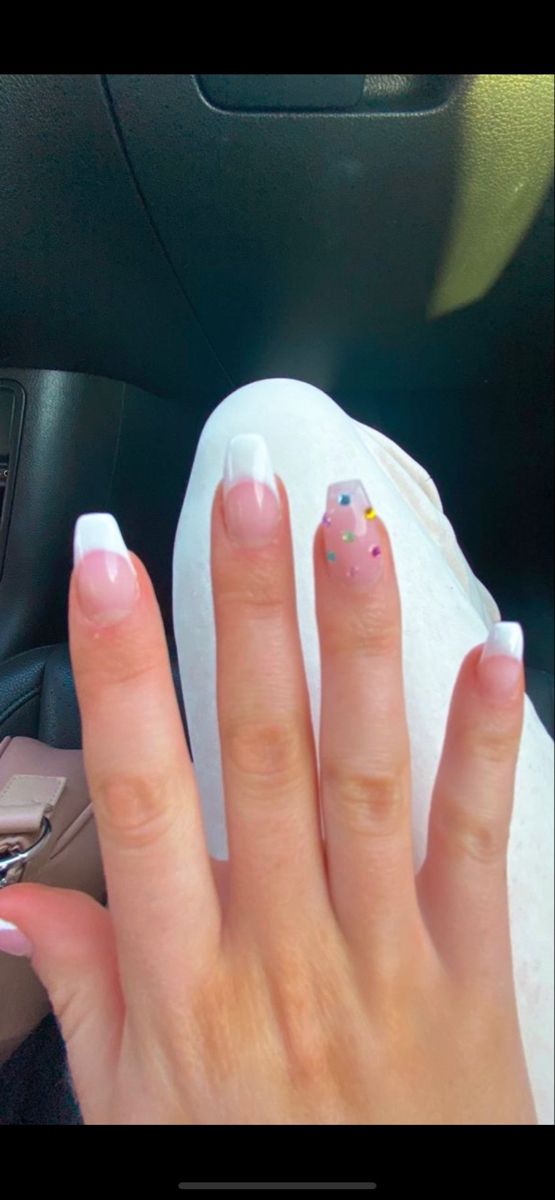 Playful French Tip Manicure with Colorful Sprinkles for a Whimsical Elegance.