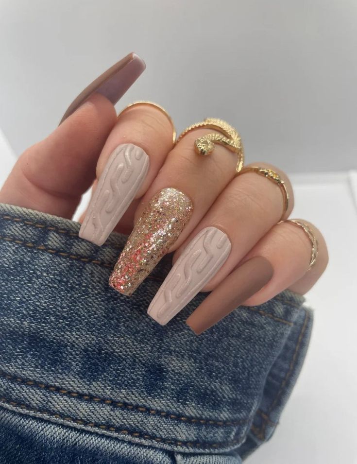 Elegant Nail Design: Textured Glossy Finish with Neutral Tones and Glitter Accents.