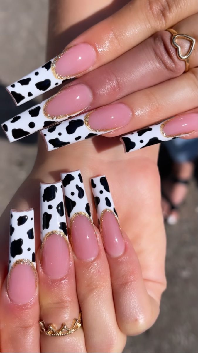 Chic Cow Print Nail Art with Elegant Accents and Bold Patterns.