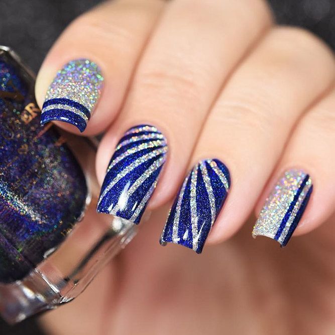 Bold Manicure: Shiny Blue Base with Swirling Silver Stripes and Glitter Accents