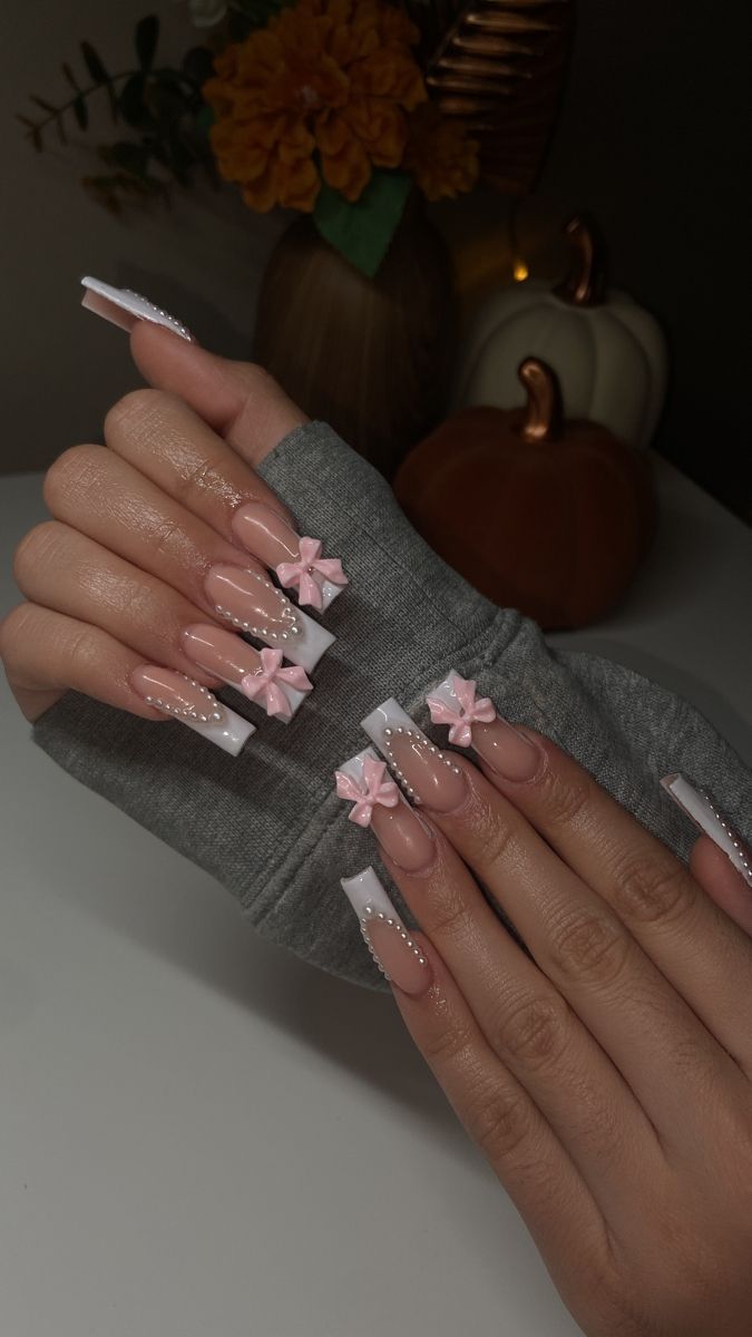 Chic Acrylic Nail Design with Soft Pink Bows and Pearl Accents