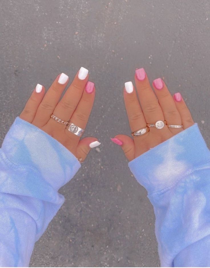 Chic Playful Nail Design with Alternating White and Pink Shades Enhanced by Delicate Rings.