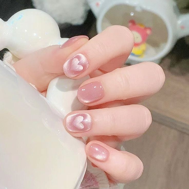 Charming Heart-Themed Nail Design in Soft Pink with Shimmering Finish