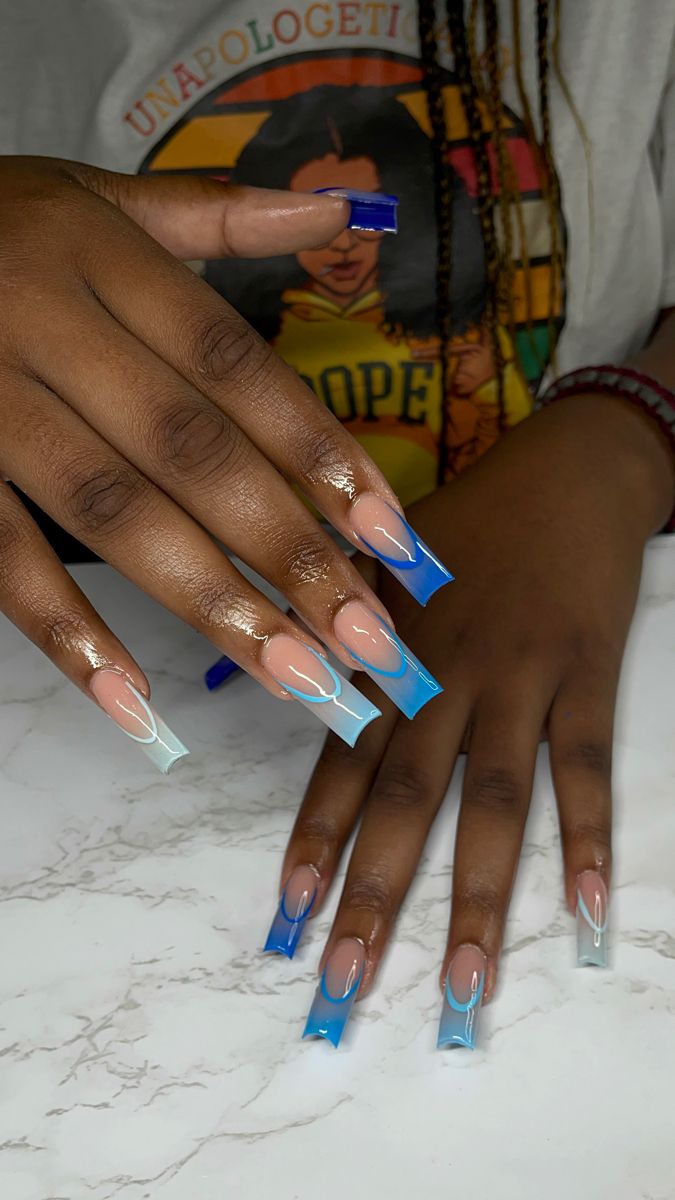 Elegant Ombre Acrylic Nails with Translucent Blue Tips and Intricate White Lines.