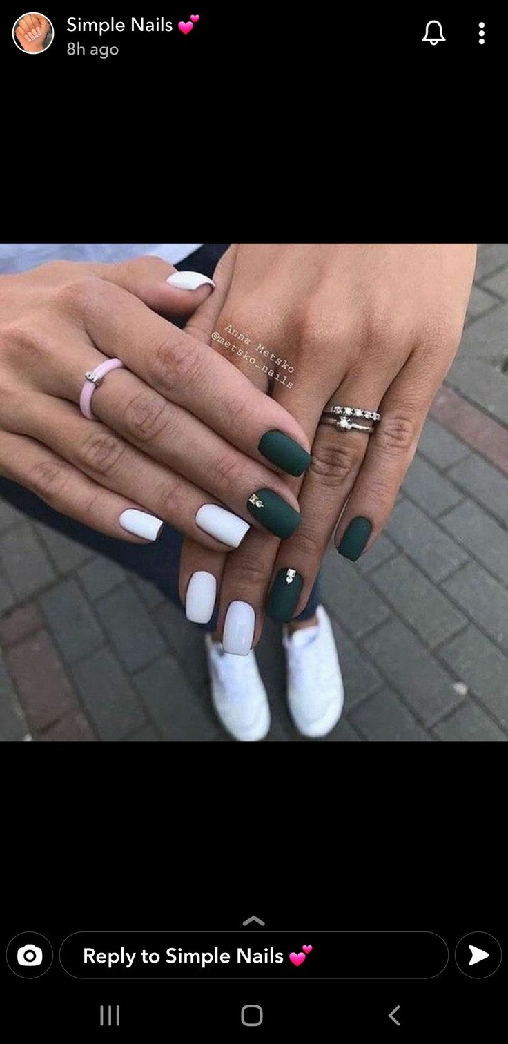 Chic Matte Deep Green and Glossy White Nail Design with Elegant Accents.