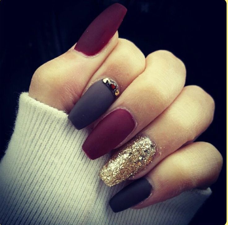 Chic Nail Design: Deep Maroon, Matte Gray, and Glamorous Gold Accent with Gem Embellishments.