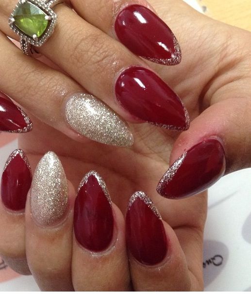 Chic Burgundy and Gold Almond Nail Design with Glitter Accents