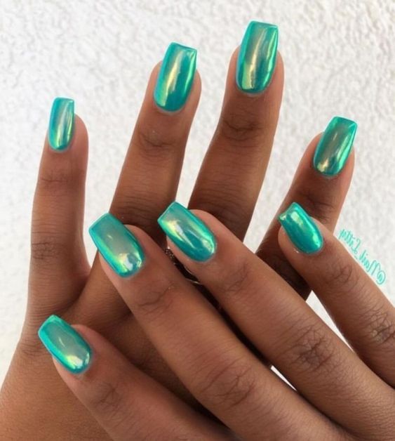 Chic Vibrant Turquoise Nail Design: Glossy Finish with Solid and Marbled Effects in Angular Shapes.