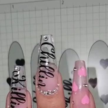 Chic Nail Design: Long Clear Tips with Playful Pink Hearts and Bold Black Lettering