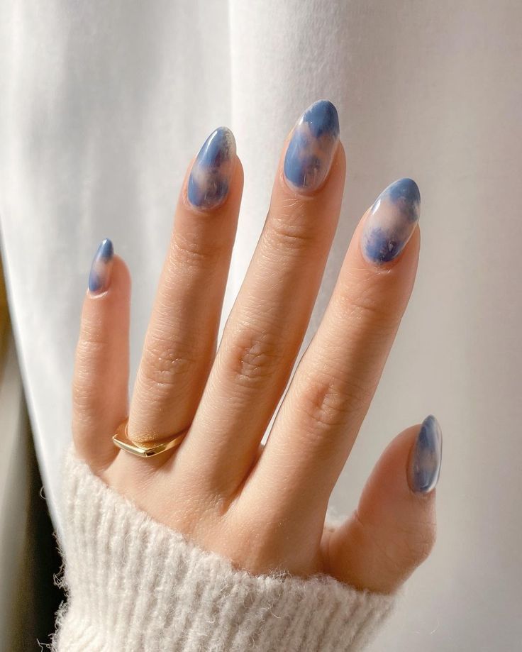 Chic Ombre Blue Nail Design with Glossy Finish and Almond Shape.