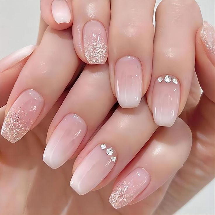 Sophisticated Ombre Nail Design with Glitter Accents and Rhinestones.