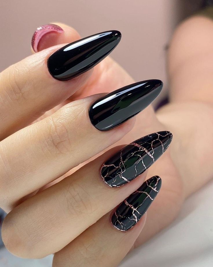 Sophisticated Elegant Black Stiletto Nails with Intricate Design and Golden Accents.