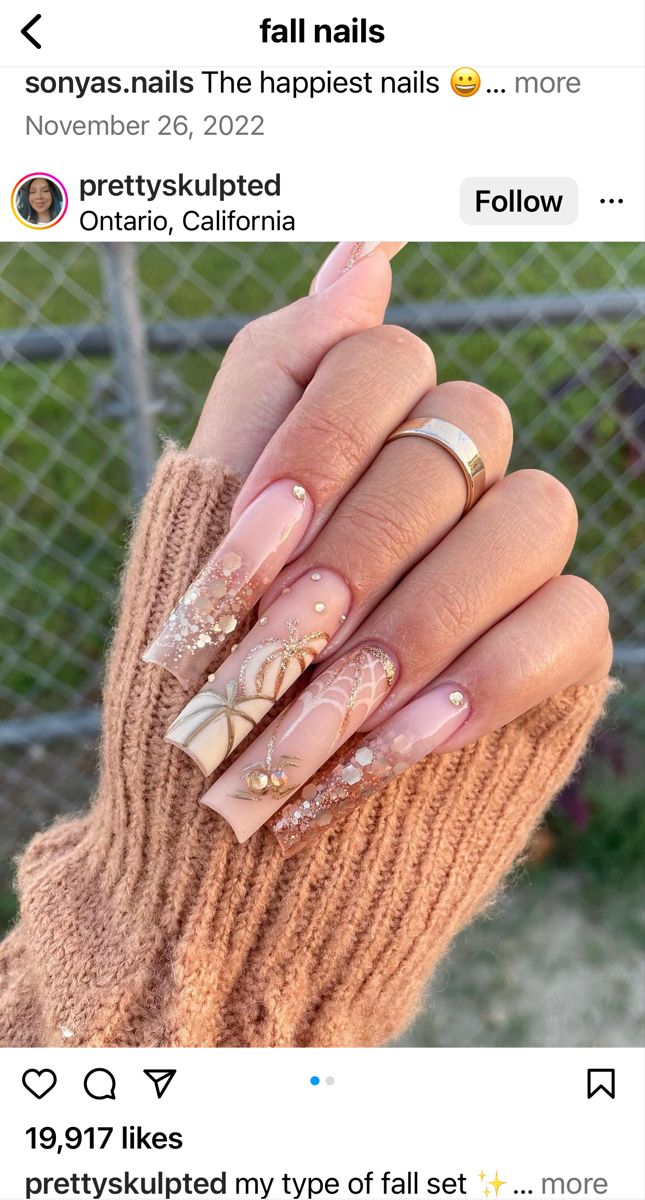 Chic Fall Nail Design: Soft Nude and Pale Pink with Gold Patterns and Rhinestones.