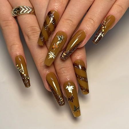 Captivating Autumn-Inspired Nail Design with Brown Base, Gold Accents, and Leaf Decor