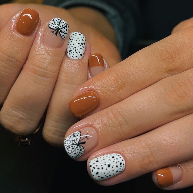 Elegant Earthy Nail Design with Playful Patterns and Glossy Finish.