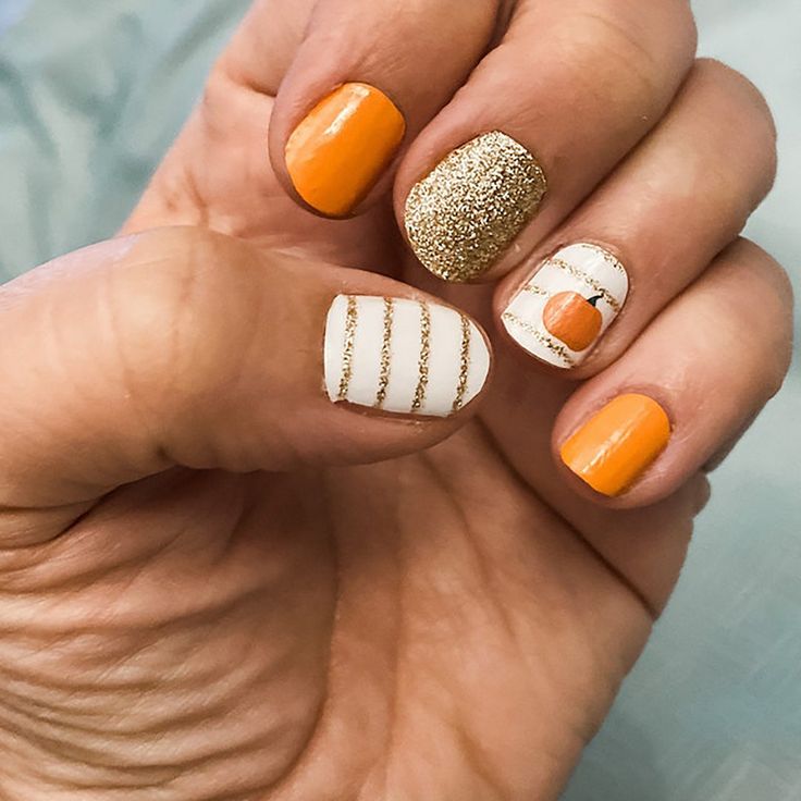 Playful Orange and Gold Textured Nail Design with Glittery Accents.