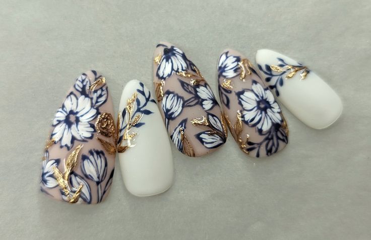 Elegant Floral Nail Design with Navy and Gold Accents for a Chic, Artistic Look