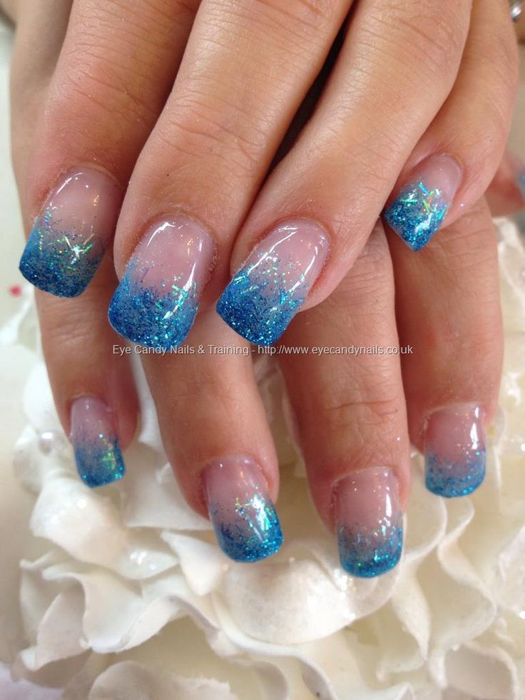 Mesmerizing Ombre Blue Nail Design with Glitter Accents and Soft Nude Bases.