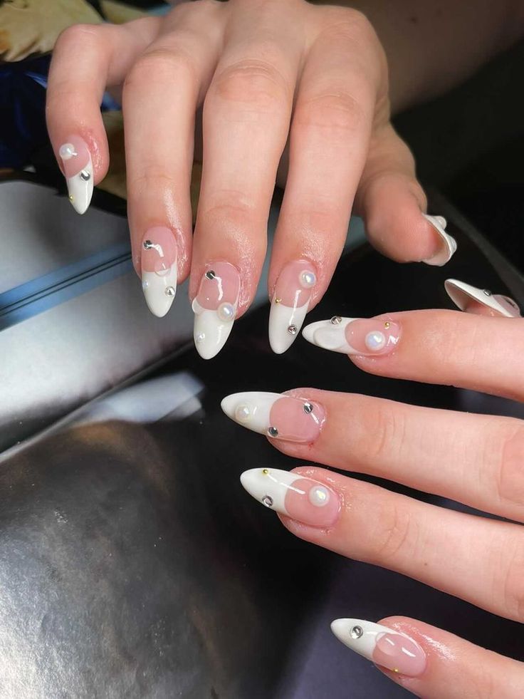 Chic Soft Nude and Crisp White Nail Design with Silver Accents and Pearls.