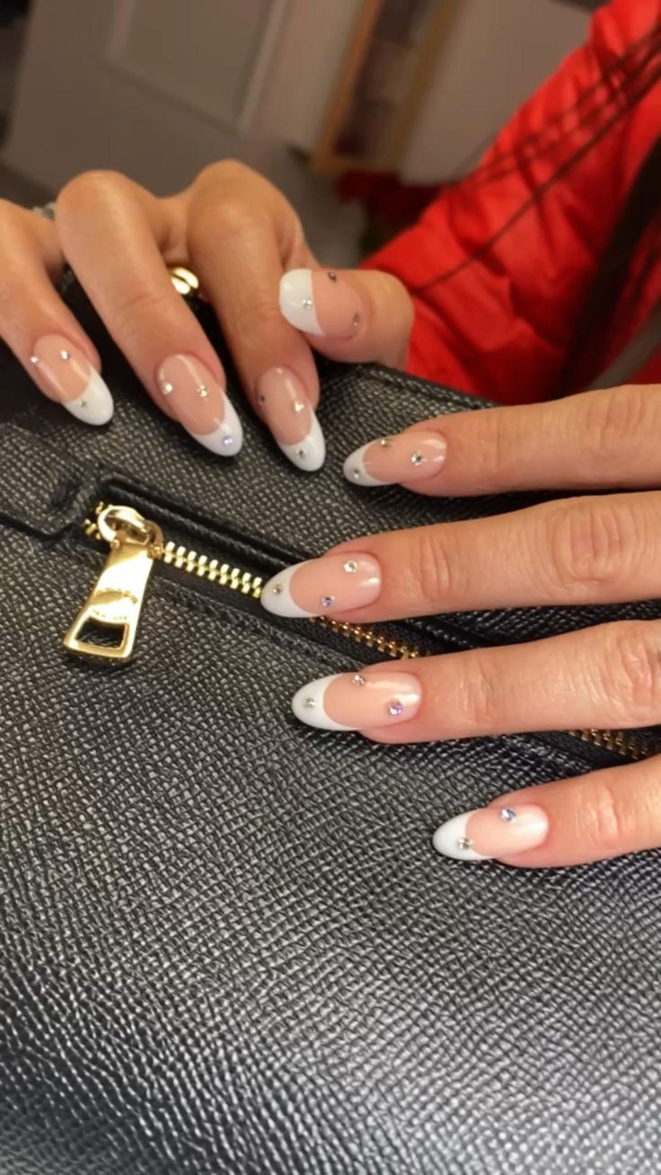 Chic Elegant French Tip Nails with Rhinestone Embellishments for Sophisticated Occasions.