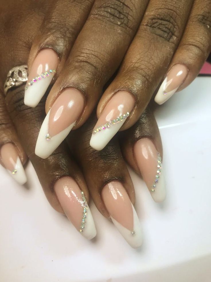 Sophisticated French Tip Nail Design with Chic Nude Base and Rhinestone Accents.