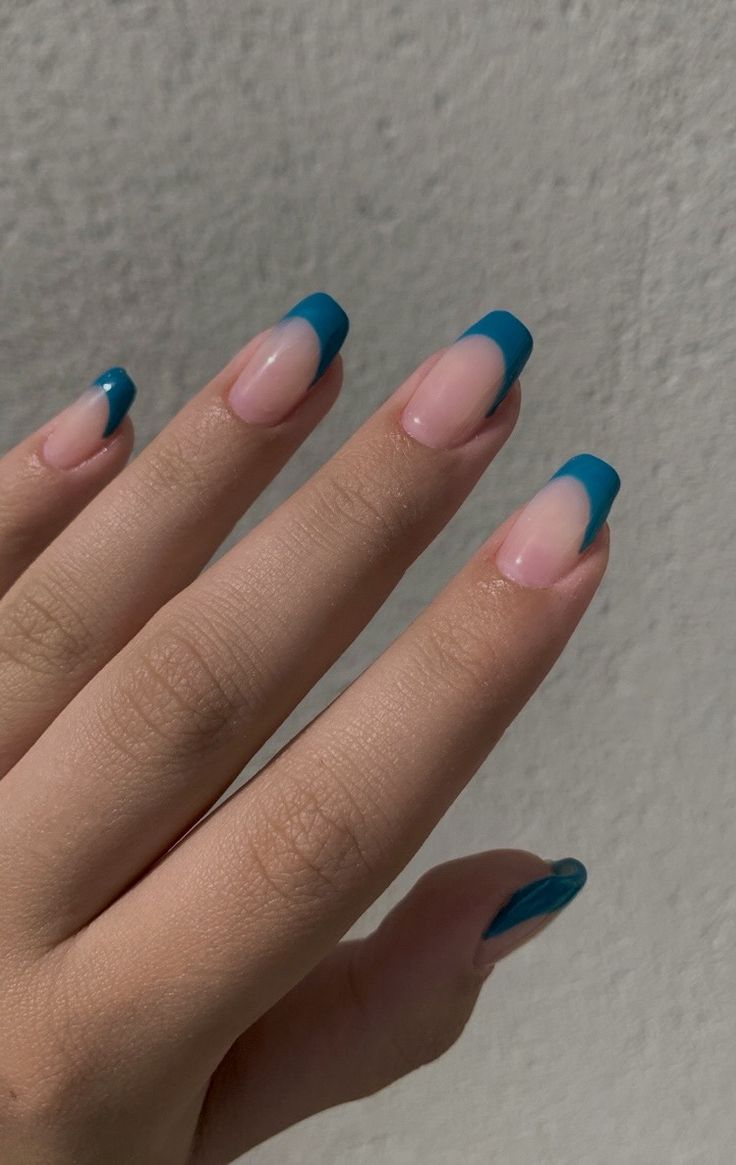 Chic Nail Design: Soft Pink Base with Bold Blue Tips for a Modern Elegance.