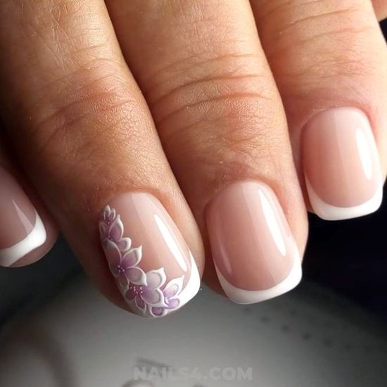 Sophisticated Nude French Tip Nails with Floral Accents in Soft Purple.